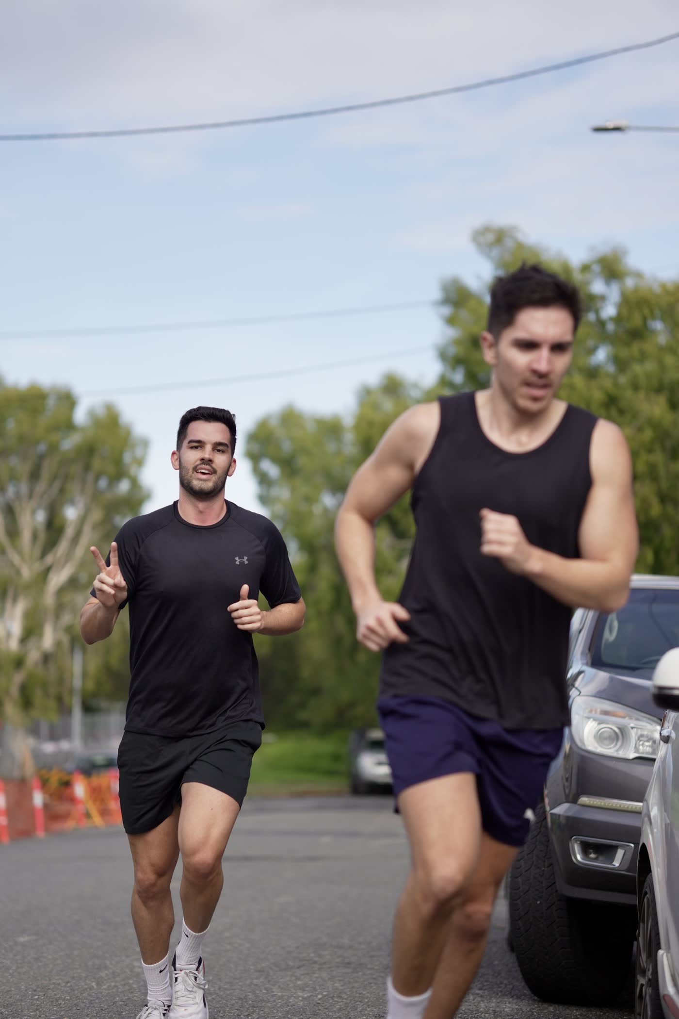Two athletes running outside CrossFit Brisbane