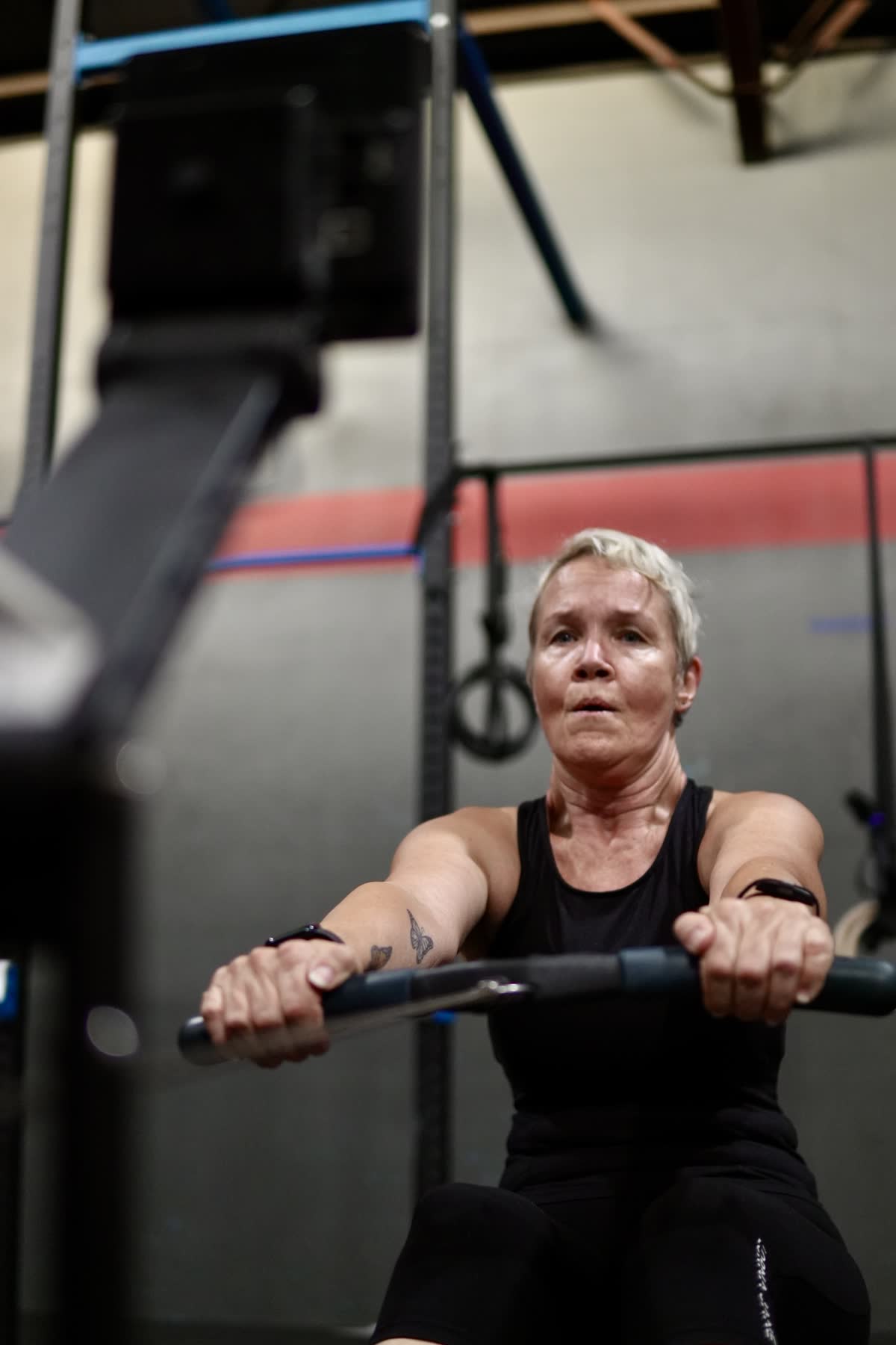 Older CrossFit Brisbane athlete rowing during a Vitality session