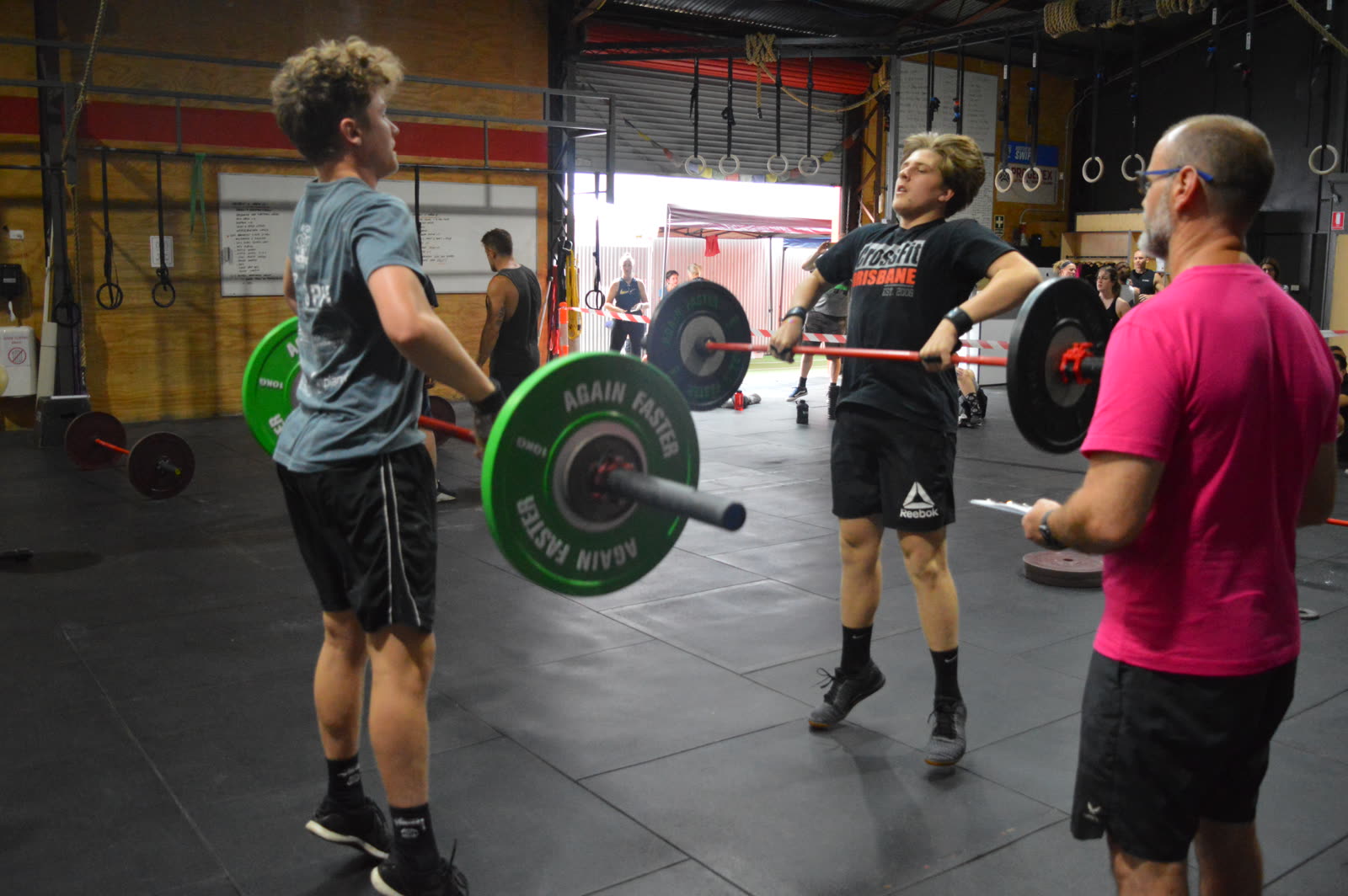 CrossFit Brisbane coach guiding teens through barbell technique